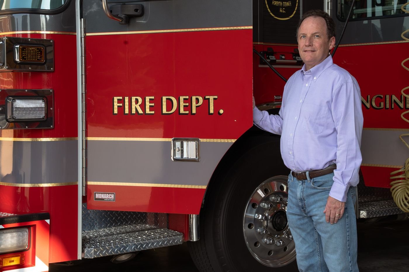 Chris Parker standing beside a fire engine